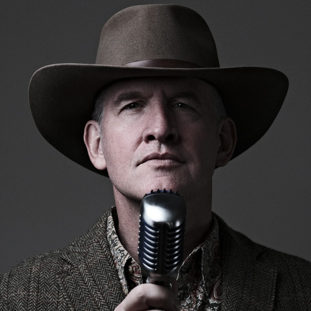 A portrait of Michael Scherer, in front of a microphone.